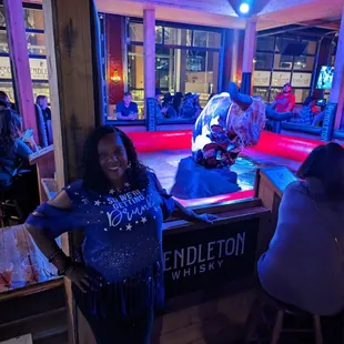  a woman standing in front of the bar