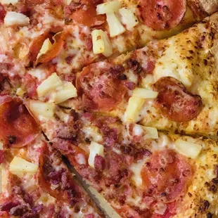 Pepperoni, bacon, and pineapple pizza
