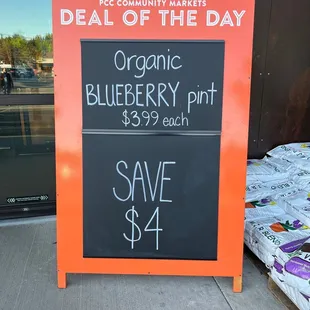 a blackboard with a price of blueberry pie