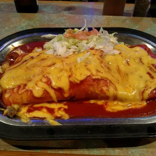 Beef burrito with beans and potatoes, smothered in red chile