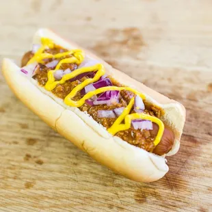 a hot dog with mustard and onions