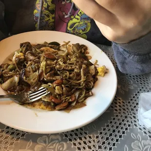 a person taking a picture of a plate of food
