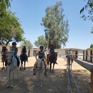 Summer camp volunteers going out on a well deserved trail ride