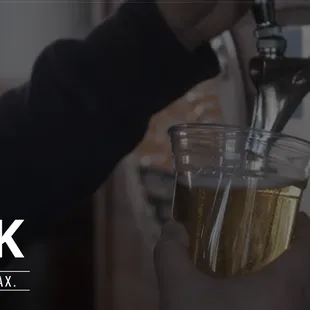 a person holding a glass of beer