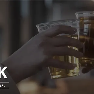 two people toasting with drinks