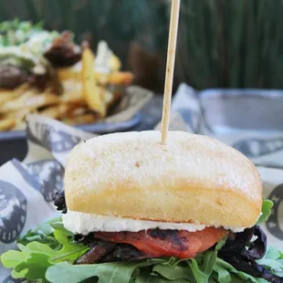 a sandwich with lettuce and tomato