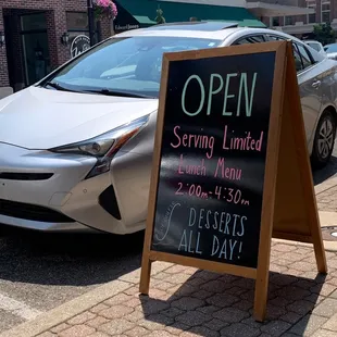 a sign for optm serving limited desserts all day