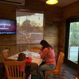 a woman and child sitting at a table