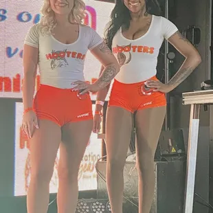 two women in orange shorts