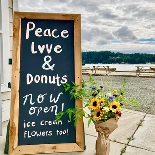 a sign with flowers in a vase