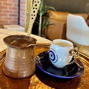 a cup of coffee and a spoon