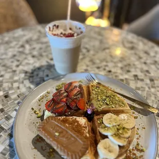 a plate of waffles and fruit
