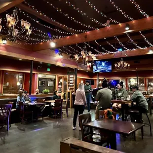 people sitting at tables in a restaurant