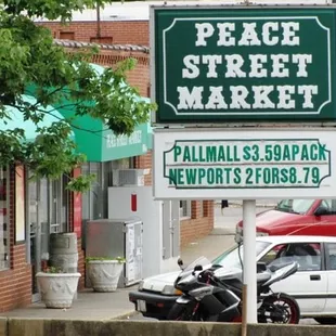 a motorcycle parked in front of the sign