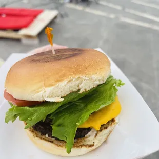 a hamburger with lettuce and cheese