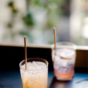 two glasses of cocktail on a table