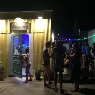 people standing outside at night