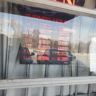 Hours, hard to read due to glare - my apologies