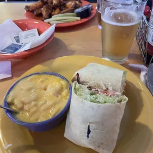 Chicken wrap and Mac and Cheese. Wings on the other side of the table.