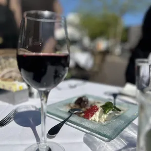 a plate of food and a glass of wine