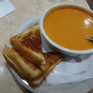 a bowl of soup and a grilled cheese sandwich