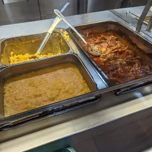 three pans of food on a counter