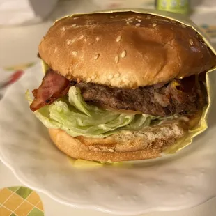 a hamburger with lettuce and bacon