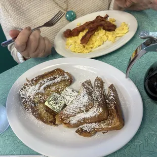 French toast with scrambled eggs and bacon.