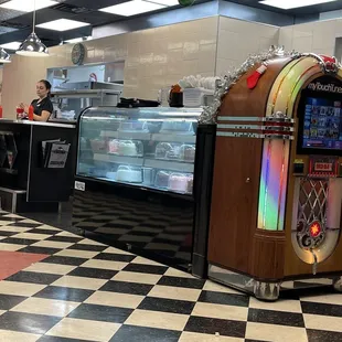 Beautiful classic juke box &amp; bakery case with locally made cake!