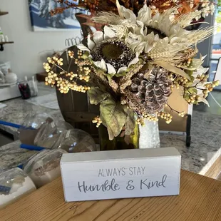 a vase of dried flowers on a table