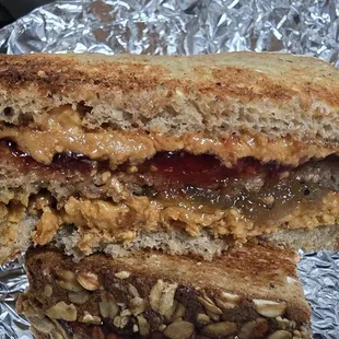 Double Decker on 7 grain wheat bread with natural peanut butter and strawberry kiwi jam