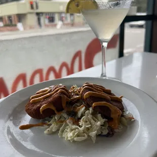 a plate of food and a martini