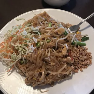 a plate of noodles with meat and vegetables