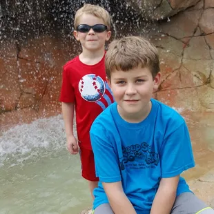 Great Grandsons playing mini golf.