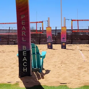 a beach with chairs and umbrellas