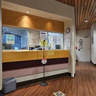 Check in at the window... stand on the white square for temperature reading