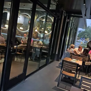 a group of people sitting at tables in a restaurant