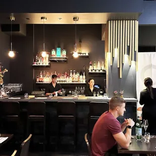 a group of people sitting at a bar
