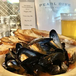 a plate of mussels and bread