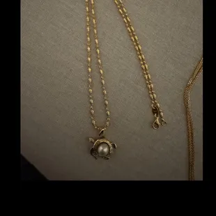 Sea turtle pendant with pearl inlay.