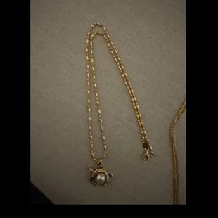 Sea turtle pendant with pearl inlay.