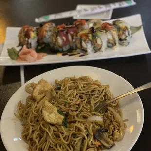 a plate of noodles and a plate of sushi