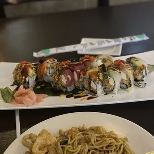 a plate of noodles and a plate of sushi