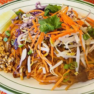 a plate of noodles with meat and vegetables