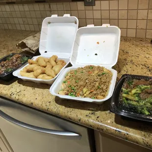 a variety of food in containers on a kitchen counter