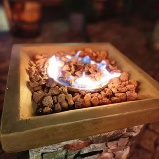a fire pit with rocks and gravel