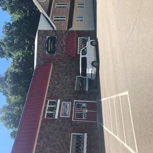 a white van parked in front of a brick building