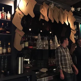 a man and a woman standing in front of a bar