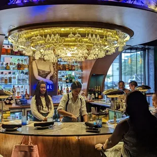 a group of people sitting at a bar