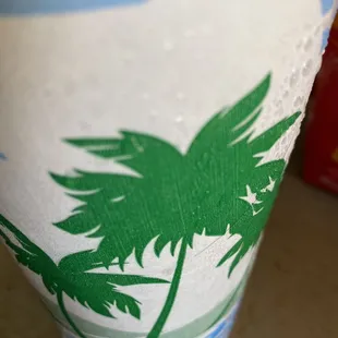 a palm tree painted on a cup